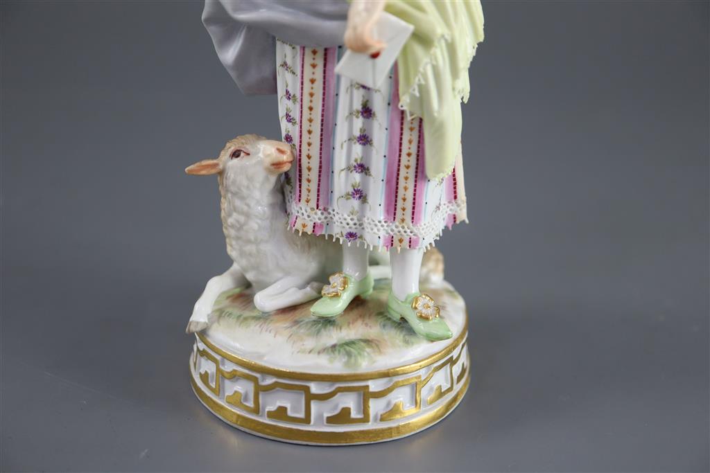 A Meissen figure of a shepherdess releasing a bird from a cage, 19th century, 17.5cm high